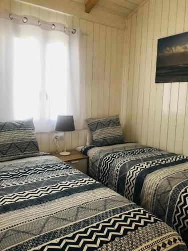a room with three beds and a window at Camping Lo Monte in Pilar de la Horadada