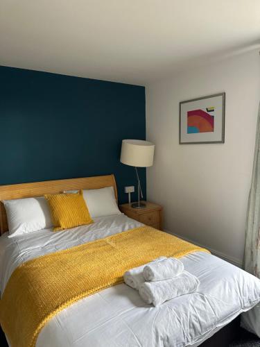 a bedroom with a bed with two towels on it at Continental Hotel with access to shared kitchen in Hull