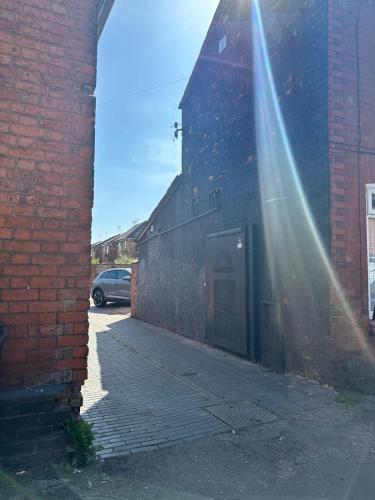 a beam of sunlight shining on a brick building at Bedford Street Flats in Crewe