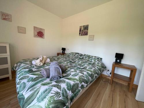 a person laying on a bed in a bedroom at Lilas - Spacieuse maison 10 pers Jardin BBQ in Doumen