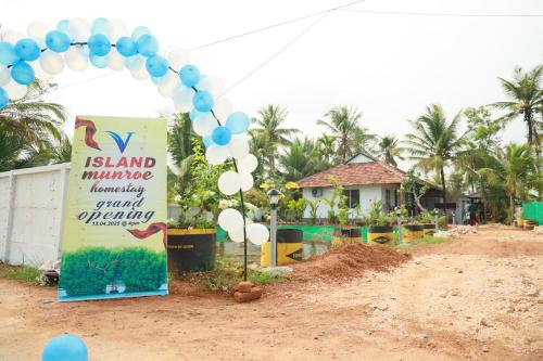 a arch with blue and white balloons and a sign at V island mundro in Munroe Island