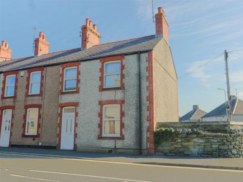 a brick building on the side of a street at 63 Kingsland Road in Holyhead