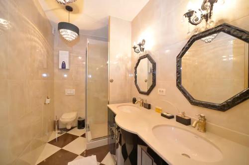 a bathroom with a sink and a shower and a mirror at Captain Studio in Kotor