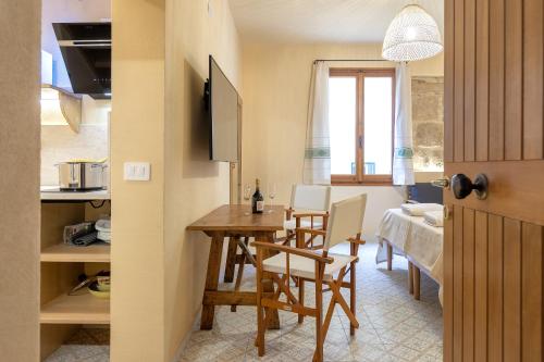 a kitchen and dining room with a table and chairs at Suite Buragna Exclusive Retreat in Alghero