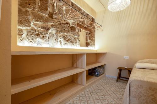a room with a bed and a wall at Suite Buragna Exclusive Retreat in Alghero