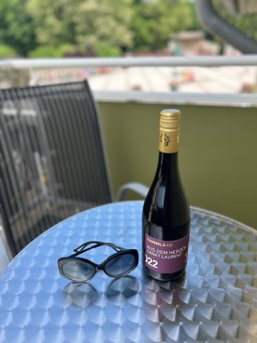 a bottle of wine and a pair of glasses on a table at Hotel Ostseeblick - direkt hinter den Dünen in Ostseebad Karlshagen