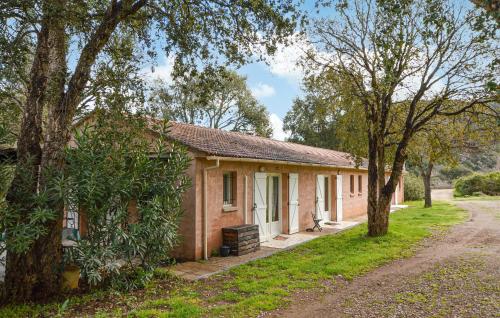a small brick house with trees in front of it at 1 Bedroom Nice Home In Vignale in Vignale