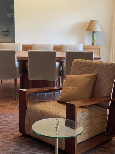 a living room with a couch and a table at Luxury Penthouse with 2 Pools in a Monastery in Tavira