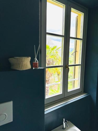 a bathroom with a window above a sink at Villa Corti in Como