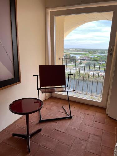 a room with a tv and a table and a window at Luxury Penthouse with 2 Pools in a Monastery in Tavira