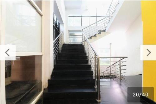 a staircase in a building with two arrows pointing up at New ELITTE INN in Trivandrum