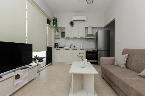 a living room with a couch and a table at Stella's Apartment Karfas in Karfas