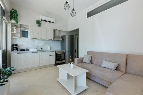 a living room with a couch and a table at Stella's Apartment Karfas in Karfas