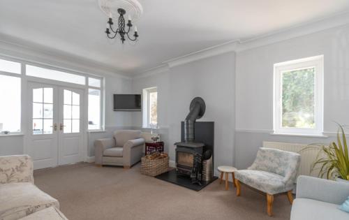 a living room with a wood stove in it at Mevagissey Bay Hotel in Mevagissey