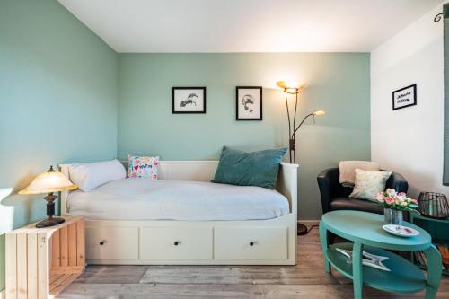 a small bedroom with a bed and a chair at Harmonie Hof in Oyten