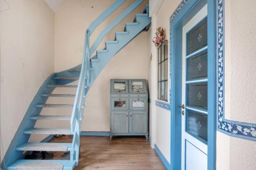 a blue staircase in a room with a blue door at Harmonie Hof in Oyten