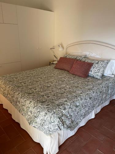 a bedroom with a large bed with a gray comforter at Luxury Penthouse with 2 Pools in a Monastery in Tavira