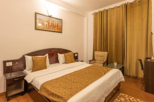 a bedroom with a large bed and a chair at Binsar Eco Resort, Binsar - Uttarakhand in Hawālbāgh