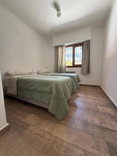 a bedroom with a large bed and a window at Del Lago Sky Hotel in San Carlos de Bariloche