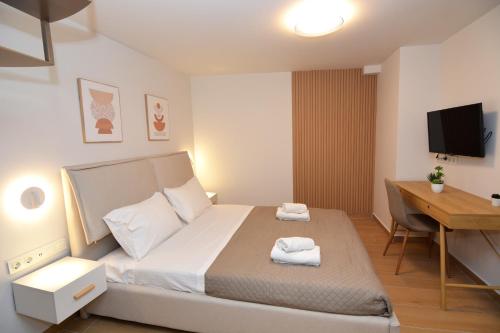 a small bedroom with a bed and a desk at Liora Retreat in Kavála