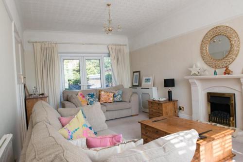 a living room with a couch and a fireplace at Mumbles - House - Seaside - Sleeps11 - PetFriendly in Swansea