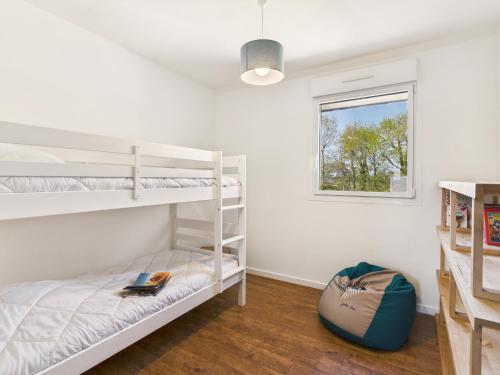 une chambre avec deux lits superposés et une fenêtre dans l'établissement Maison moderne pour 12, grand jardin, terrasse, à Concarneau