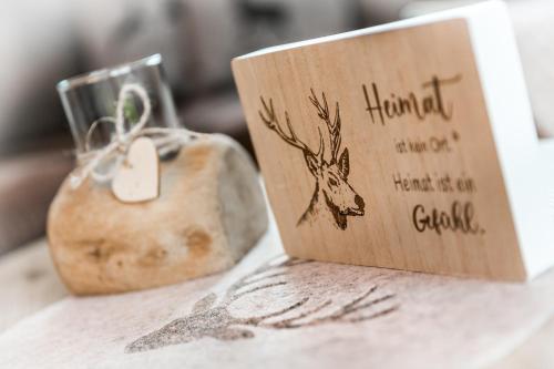 a wooden card sitting on top of a table at Chalet Hüttenzauber in Mehlmeisel
