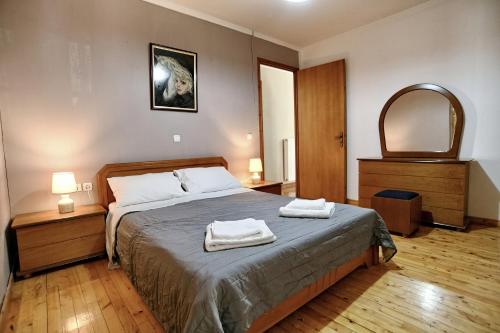 a bedroom with a bed with two towels on it at Prokopis House in Sívros