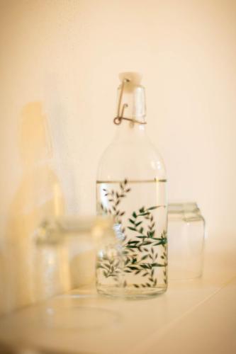 a bottle filled with water sitting on a table at Happy Home in Călimăneşti
