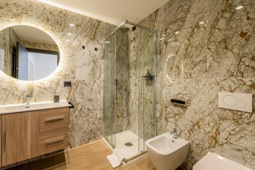 a bathroom with a sink toilet and a mirror at Villa Grace Milan in Milan