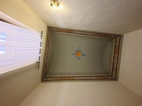 a picture on a wall in a room with a window at Palazzo Framarino dei Malatesta - Noble Floor - XIV Century in Giovinazzo