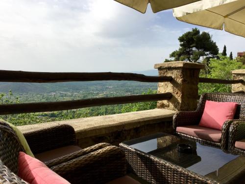 a balcony with chairs and a table with a view at Varosi 4 Seasons in Edessa