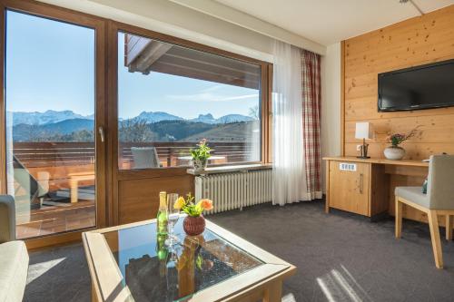 a living room with a large window with a view at Landhotel Gockelwirt in Eisenberg