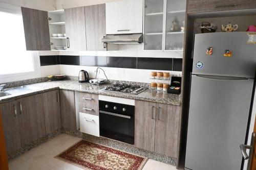 a kitchen with a refrigerator and a stove at Panorama de Maria in Asilah