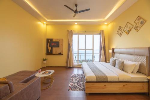 a bedroom with a bed and a couch at Binsar Eco Resort, Binsar - Uttarakhand in Hawālbāgh