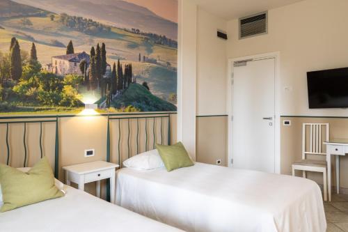 Postel nebo postele na pokoji v ubytování Hotel Le Colline
