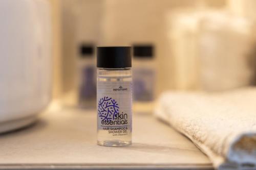 a bottle of shampoo sitting on a counter at Melian Roots Studio in Adamas