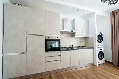 a kitchen with white cabinets and a stove at Home One Room Verona Fiera with private bathroom in Verona