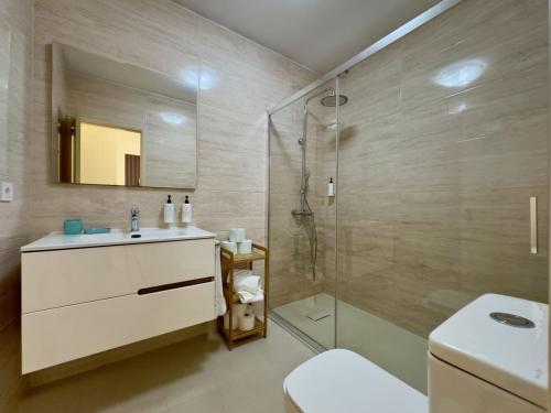 a bathroom with a shower and a sink and a toilet at Vibrant Host Solutions - Póvoa Living in Póvoa de Varzim