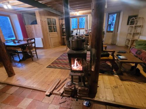 a wood stove in a living room with a table at Terre Rouge in Boulc