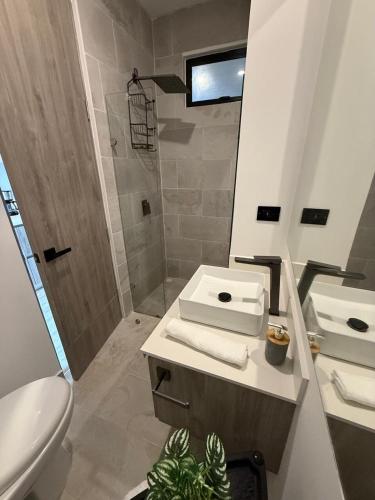 a bathroom with a toilet and a sink and a shower at Almare Apartamentos nuevos in Gustavo Rojas Pinilla International
