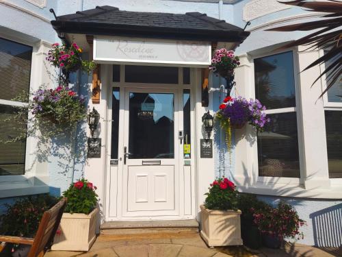 a front door of a house with flowers on it at The Rosedene in Llandudno