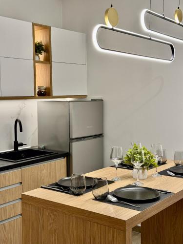 a kitchen with a wooden counter with wine glasses on it at Velvet Aura Jacuzzi Edessa in Edessa