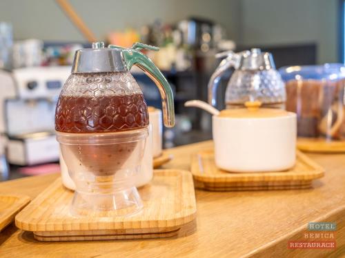 a blender sitting on a counter next to two cutting boards at Hotel Benica in Benešov