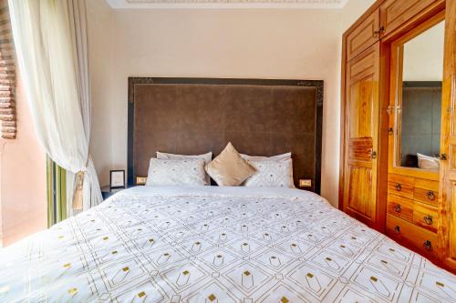 a bedroom with a large bed with a large headboard at Palm spot in Marrakech