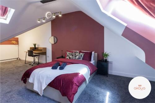 a bedroom with a bed with a purple wall at Long Stay Luxury and Comfort Escape in Manchester in Reddish