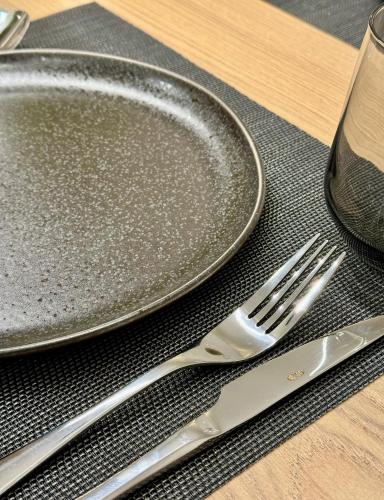 a plate and a fork and knife on a table at Velvet Aura Jacuzzi Edessa in Edessa