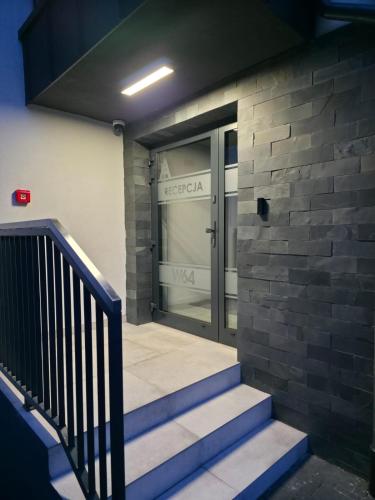 an entrance to a building with a glass door at W64 Apartamenty in Płock