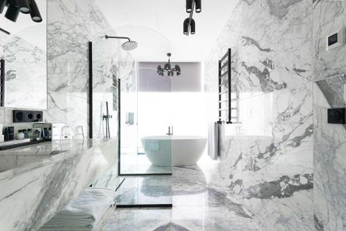 a bathroom with a white tub and a sink at Tsinandali Estate, A Radisson Collection Hotel in Tsinandali