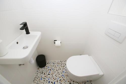 a bathroom with a white toilet and a sink at Villa Ula Premium Apartments ,Free Private PARKING in Opatija